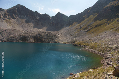 Landscape of highland lake high in the mountains of Dombai. Circus formed by a glacier with a deep lake and blue water