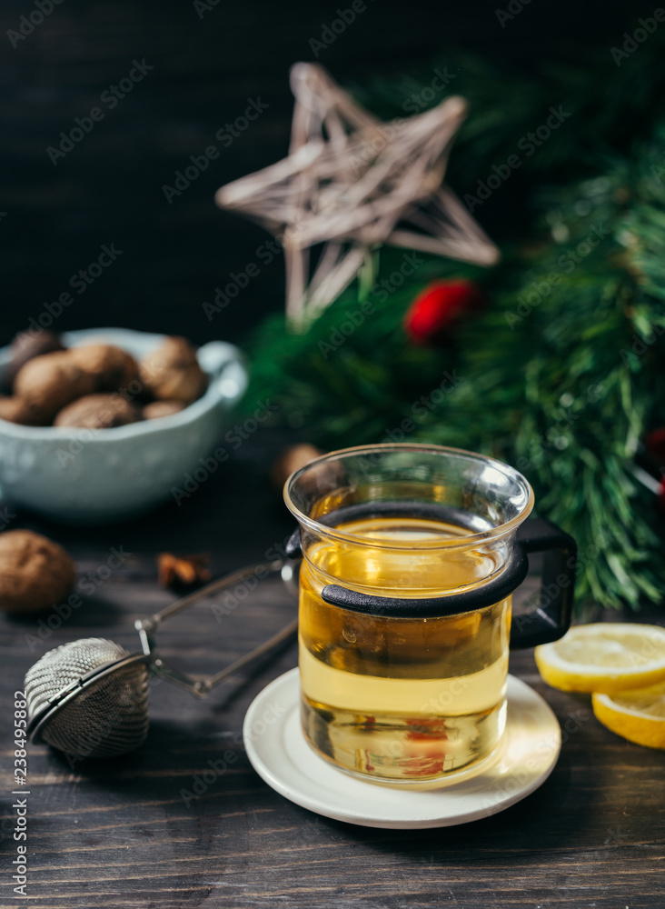 cup of tea on wooden table with blurred christmas tree in background cup of tea on wooden table with blurred christmas tree in background