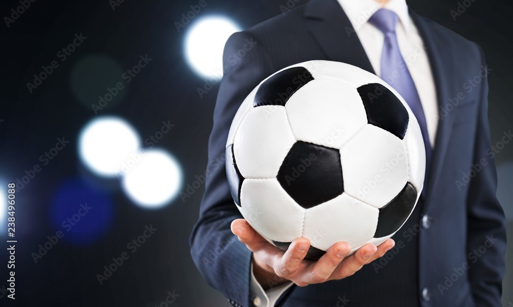 Close-up young male businessman holding Soccer ball Close-up young male businessman holding Soccer ball