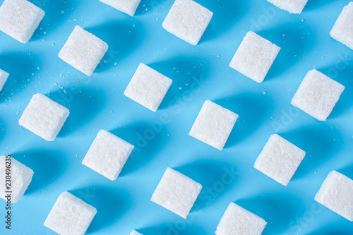Wallpaper Mural Pattern of sugar refined cubes with shadows on a blue background. Concept of harmful ingredient for confectionery Torontodigital.ca