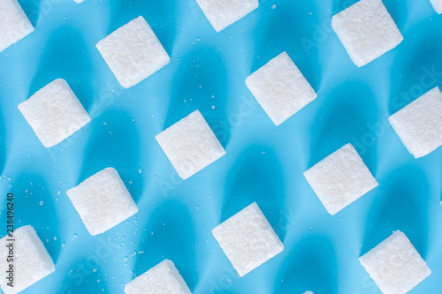 Wallpaper Mural Pattern of sugar refined cubes with shadows on a blue background. Concept of harmful ingredient for confectionery Torontodigital.ca