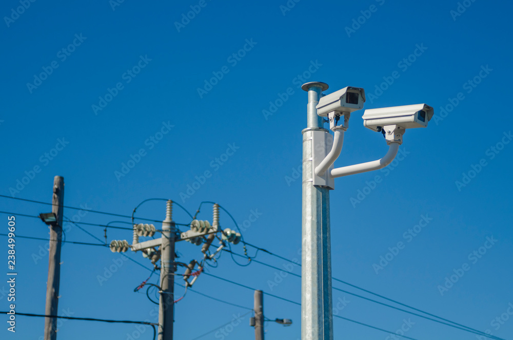 Closed circuit television surveillance cameras and electricity power lines  Stock Photo | Adobe Stock