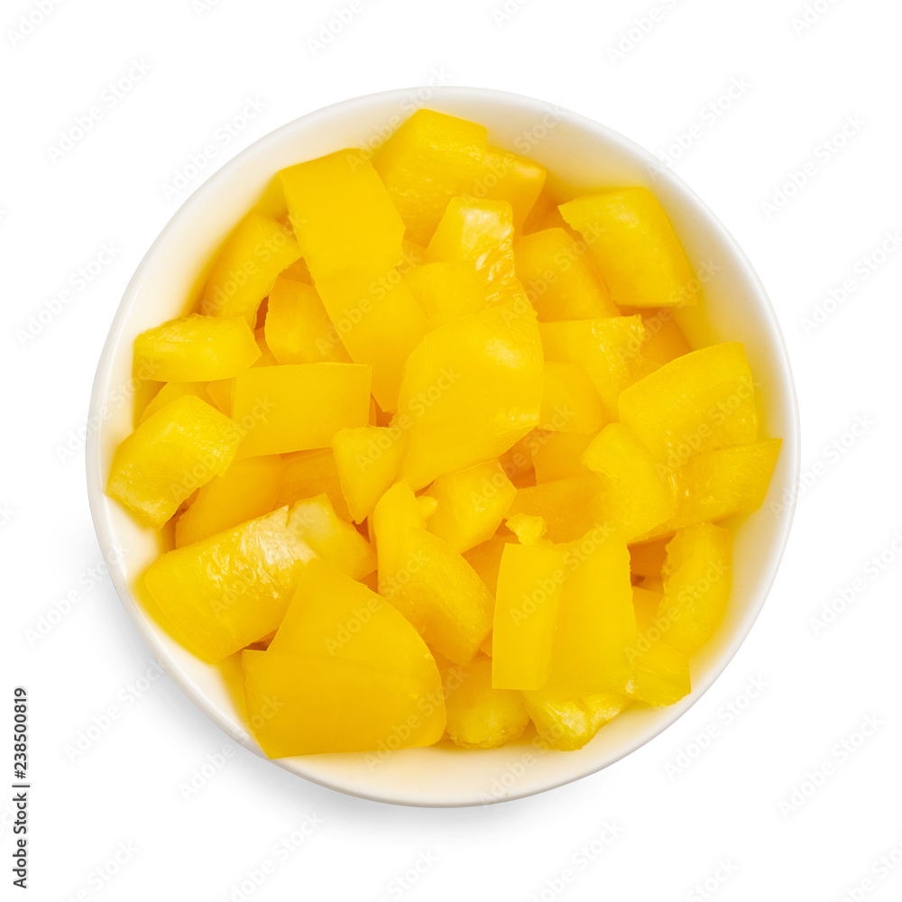 Chopped yellow pepper in bowl isolated on white background. Top view Chopped yellow pepper in bowl isolated on white background. Top view