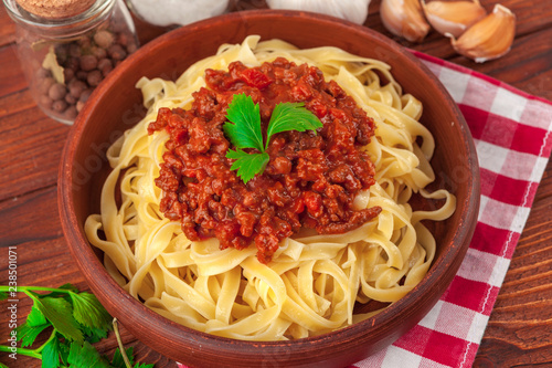Pasta with meat, tomato sauce and vegetables on the table