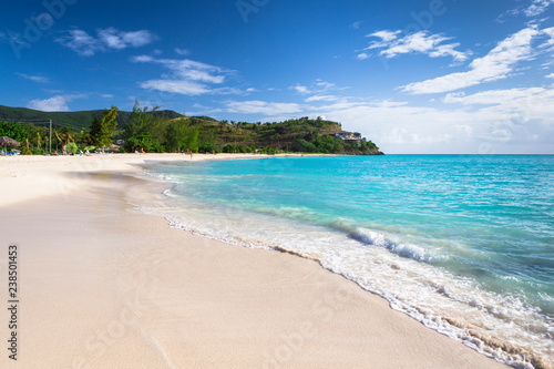 Tropical beach at Antigua island in Caribbean with white sand, turquoise ocean water and blue sky © Sergey Kelin