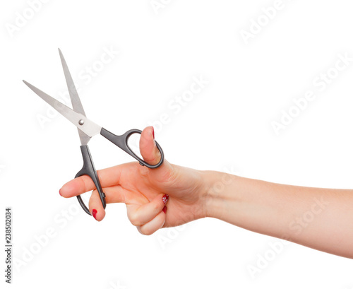 Female hand with scissors isolated on white