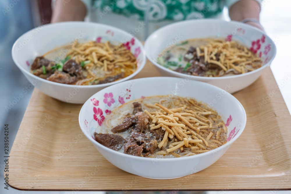 3 bowls of Khao Soi which Northern Thai Style Curried Noodle Soup with Chicken, Thai food