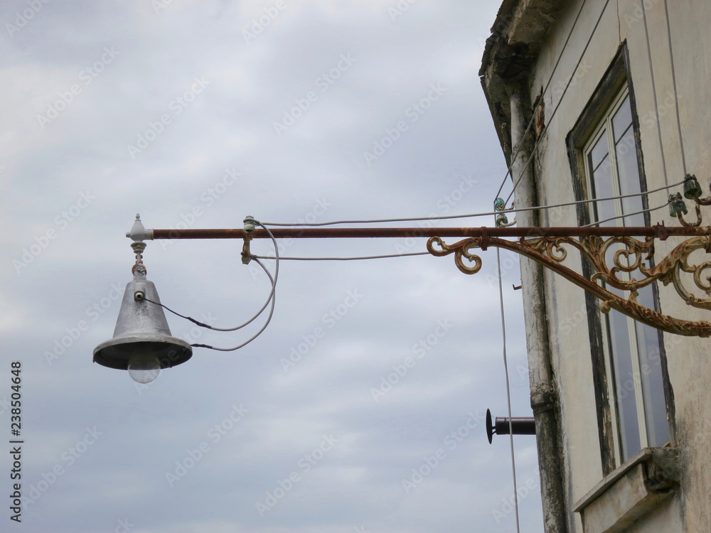 old streetlamp in the streets of Napels at the wall of a house old streetlamp in the streets of Napels at the wall of a house