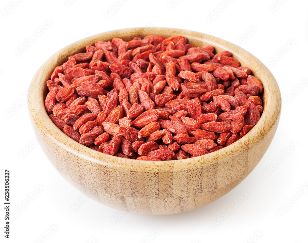 Dried goji berries in wooden bowl isolated on white background with clipping path Dried goji berries in wooden bowl isolated on white background with clipping path