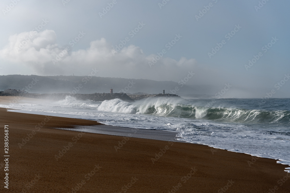 Foamy Atlantic ocean wave on Nazare city beach, Portugal. Foamy Atlantic ocean wave on Nazare city beach, Portugal.