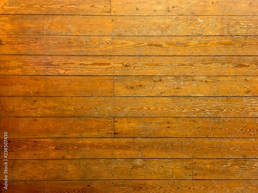 Naklejka premium Top view on an old parquet floor. Can be used as a background.