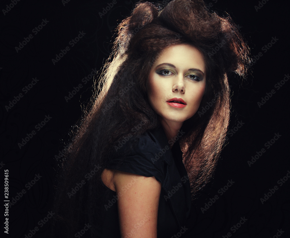 Fototapeta premium young woman with long colored brown hair and bright make-up
