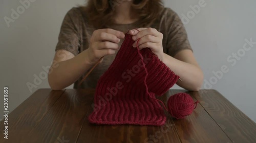 Woman knitting a red scarf