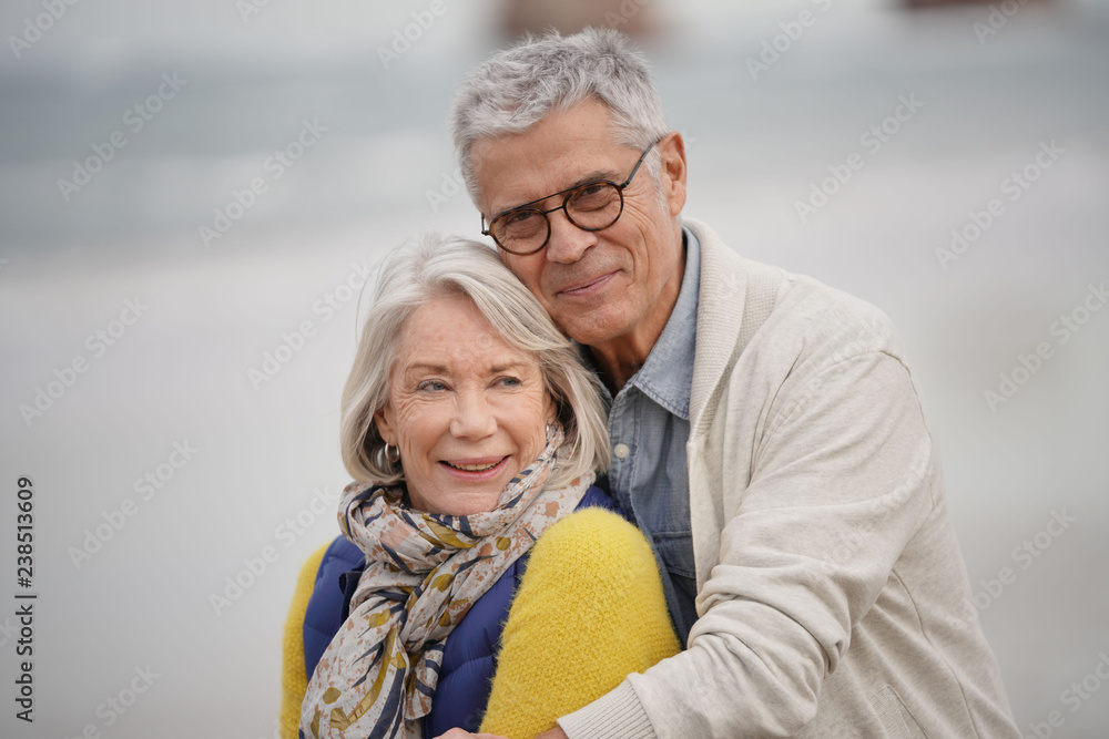  Portrait of happy senior couple embracing on the beach