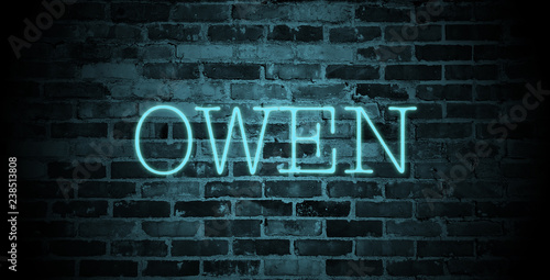 first name Owen in blue neon on brick wall © christopher-oliver