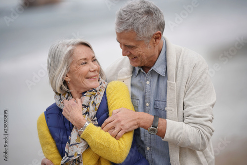  Portrait of happy senior couple embracing on the beach
