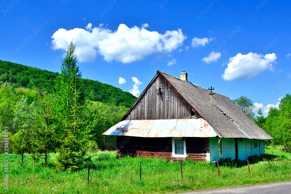 
Old wooden rural hause beside country road,  Low Beskids (Beskid Niski), Poland
