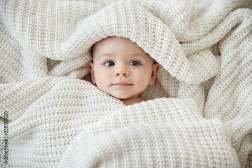 Close up of baby girl wrapped in blanket photo