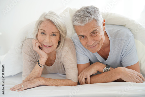  Portait of happy attractive senior couple in bed © goodluz