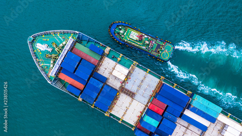 Aerial view container ship carrying container for import and export, business logistic and transportation by ship in open sea.
