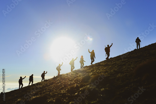 Φωτογραφία hiking activity and successful climbers on the summits of the mountains