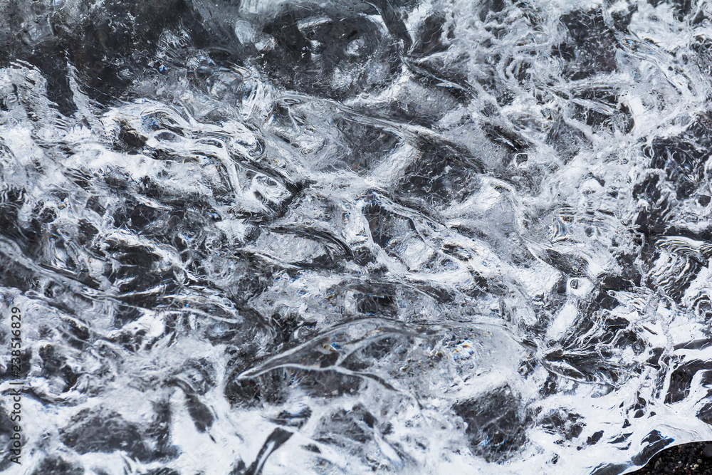 Crystal clear ice on black lava, diamond beach in iceland Crystal clear ice on black lava, diamond beach in iceland