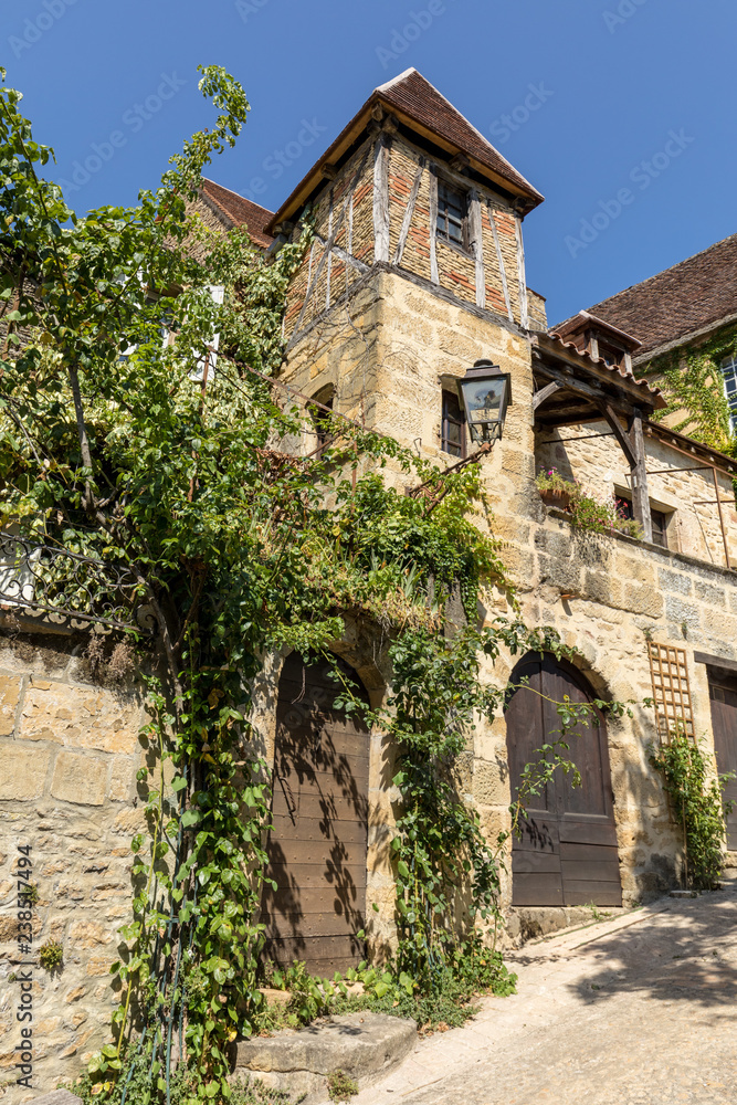 Sarlat, France - September 2, 2018: Historic houses along Montagne street in  Sarlat la Caneda in Dordogne Department, Aquitaine, France