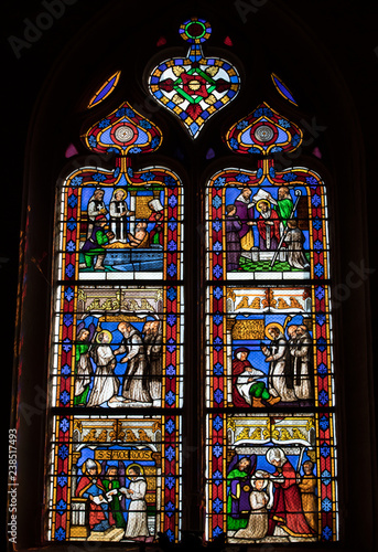  Colorful Stained Glass in medieval Sarlat Cathedral dedicated to Saint Sacerdos. Sarlat la Caneda in Dordogne Department, Aquitaine, France