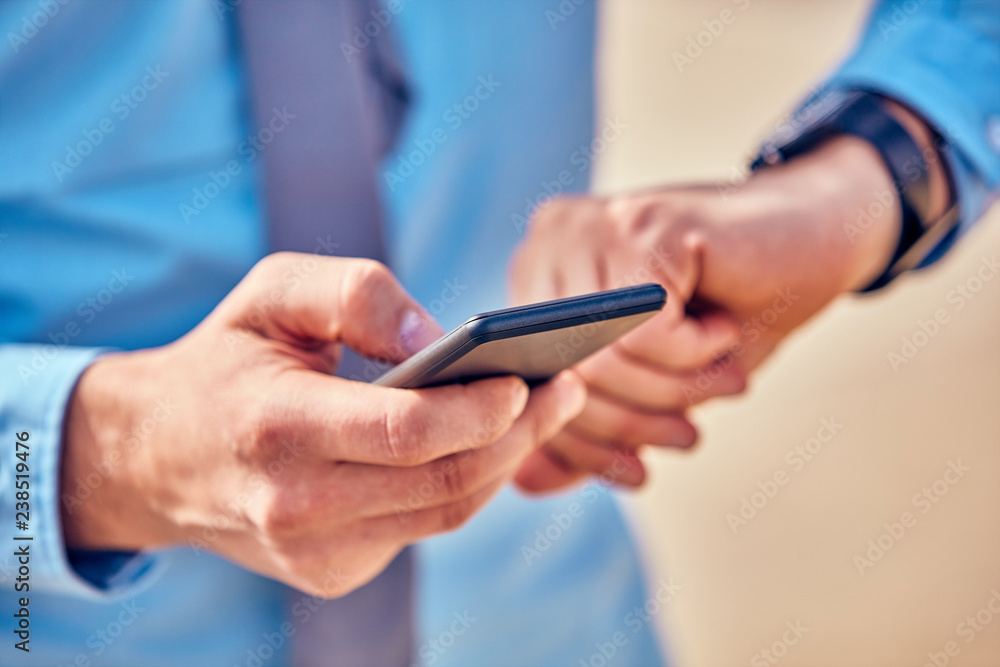 Businessman using his smartphone on the street. Businessman using his smartphone on the street.