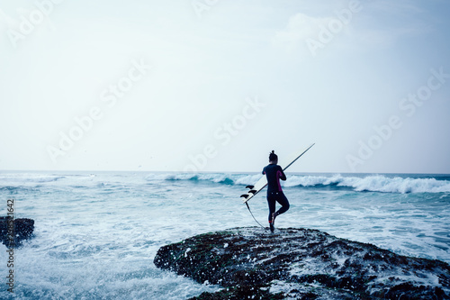 Woman surfer with surfboard going to surf