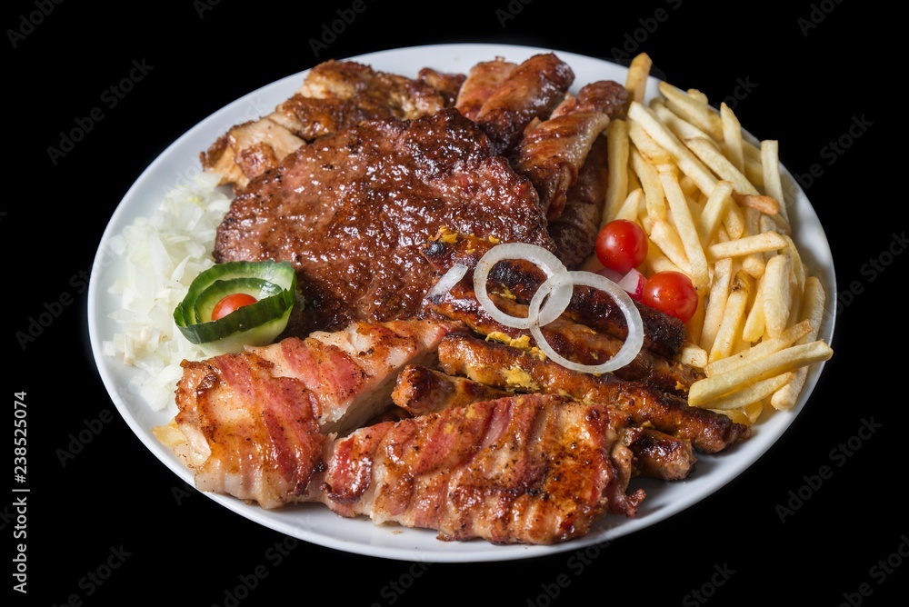 mix of grill meat on plate. hamburger with kebabs and chicken meat.