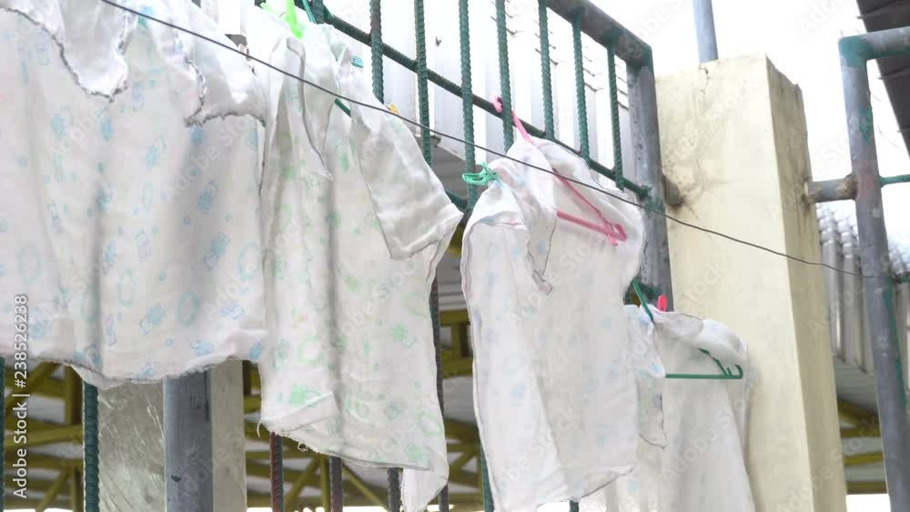 baby towels on the cloths line beside iron wall baby towels on the cloths line beside iron wall