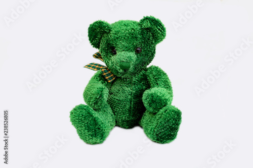 Green teddy bear with checked ribbon. Christmas gift