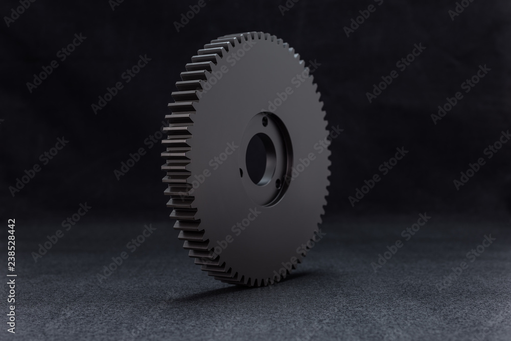 Plastic, black gear with 68 sprockets, isolated on a black background. Plastic, black gear with 68 sprockets, isolated on a black background.