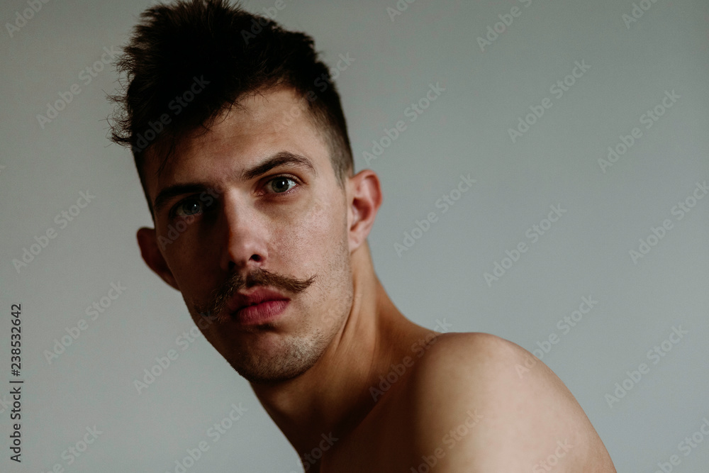 Portrait of a shirtless young man with mustache Portrait of a shirtless young man with mustache