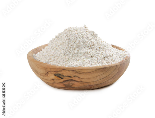 Rye flour in a wooden bowl isolated on white