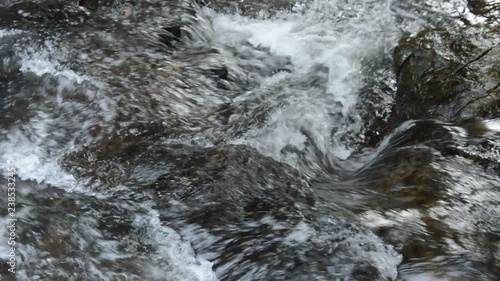 water falling on river pass rock and stone in forest