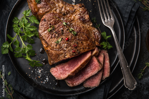 sliced beef steak on black plate photo