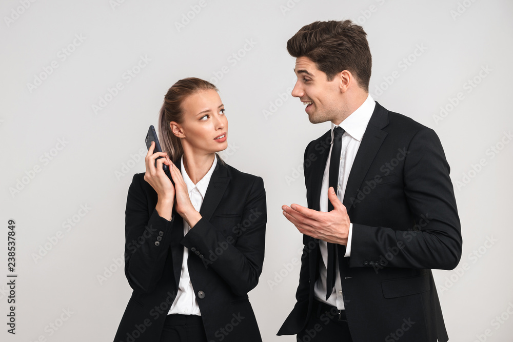 Portrait of a confident young business couple wearing suits Portrait of a confident young business couple wearing suits