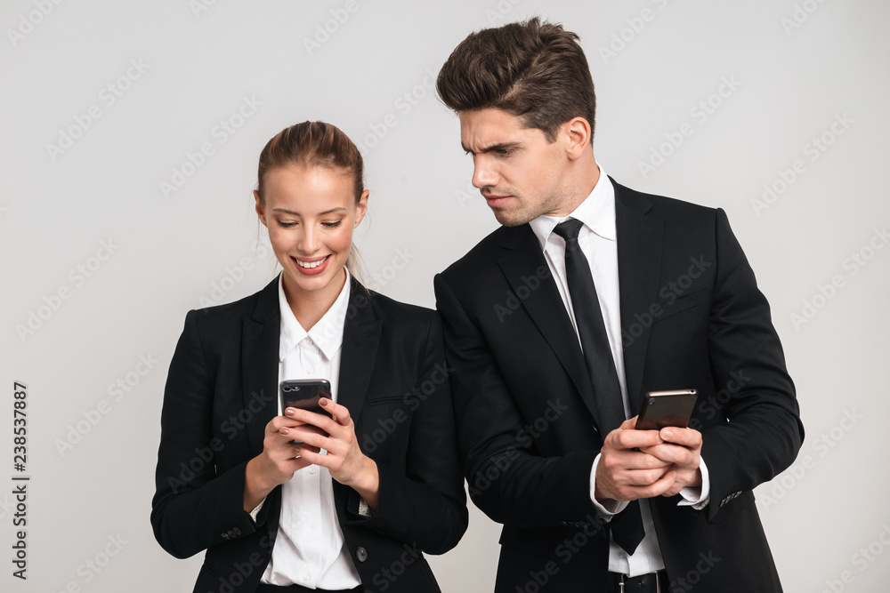 Portrait of a confident young business couple wearing suits Portrait of a confident young business couple wearing suits