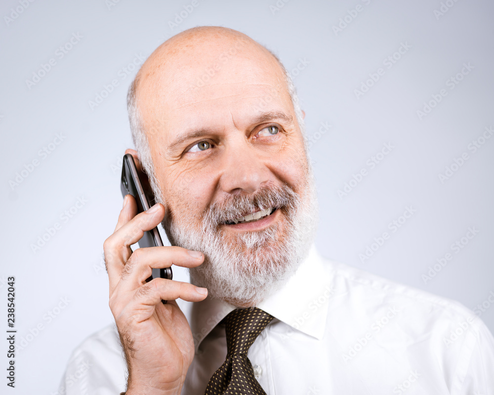 Happy mature man calling with his phone Happy mature man calling with his phone