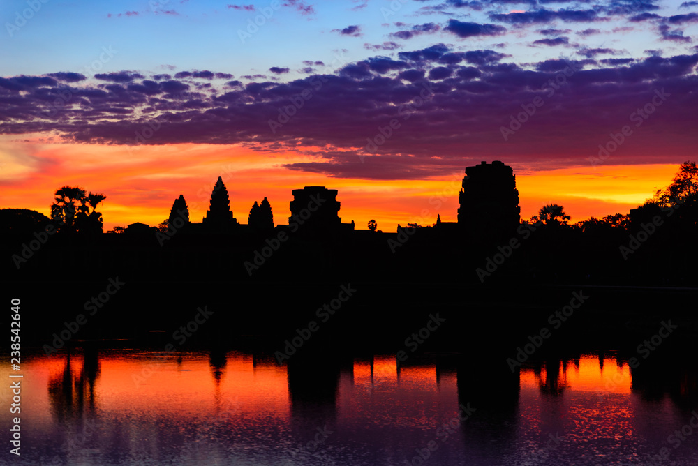 Angkor Wat night starry sky at dusk main facade silhouette reflection on water pond. World famous temple in Cambodia.