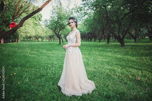 full-length portrait of the bride in a glamorous wedding dress outdoors