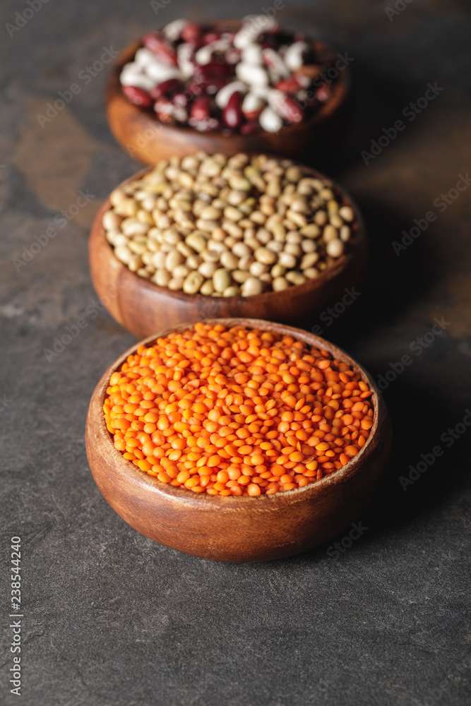 selective focus of lentils, soy and beans in wooden bowls on table selective focus of lentils, soy and beans in wooden bowls on table