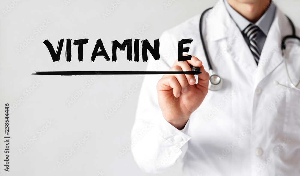 Doctor writing word Vitamin e with marker, Medical concept Doctor writing word Vitamin e with marker, Medical concept