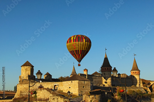 Hot Air Balloons Festival "Gold Omega 2018?. The hot air balloon flies over the Kamianets-Podilskyi castle. Autumn morning landscape. Kamianets-Podilskyi, Khmelnitsky region, Ukraine