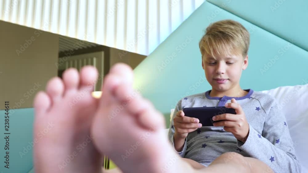 Closeup View Of Blurry Cute Small Child s Feet Boy Sitting In Bed In 