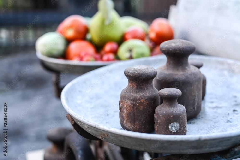 Old rusty scales weighting fruits and vegetables such as pears, tomatoes and cucumbers. country marketplace on warm autumn day, harvest festival Old rusty scales weighting fruits and vegetables such as pears, tomatoes and cucumbers. country marketplace on warm autumn day, harvest festival