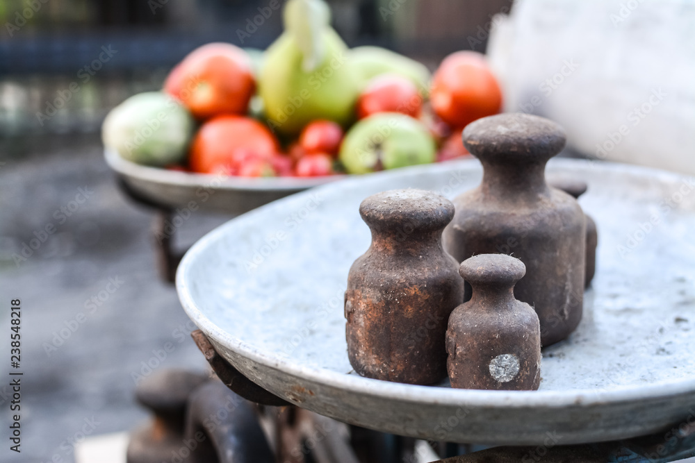 Old rusty scales weighting fruits and vegetables such as pears, tomatoes and cucumbers. country marketplace on warm autumn day, harvest festival Old rusty scales weighting fruits and vegetables such as pears, tomatoes and cucumbers. country marketplace on warm autumn day, harvest festival