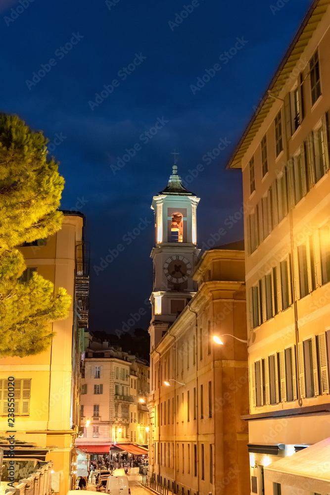 Tower bell with old clock of medieval cathedral at dusk on Place Rossetti, in France